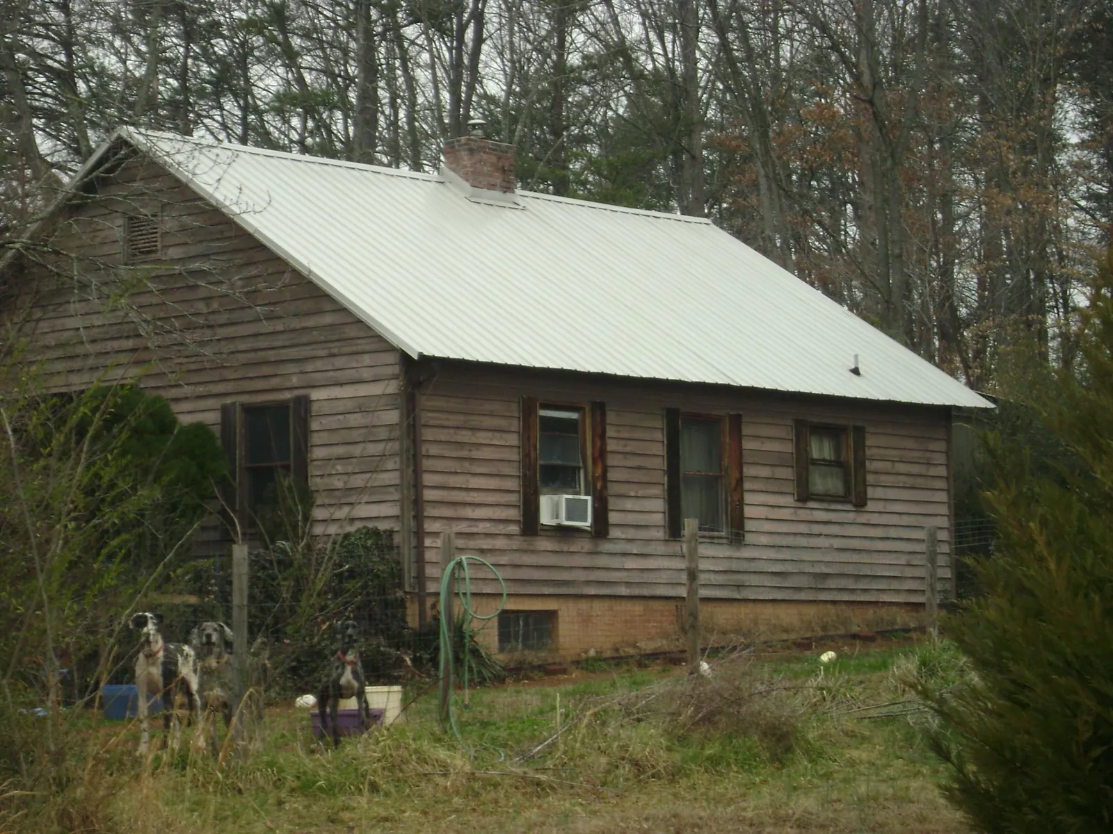 White metal roof on an old wood sided farmhouse, from a Asphalt Shingle Roof Repair job in Blairs